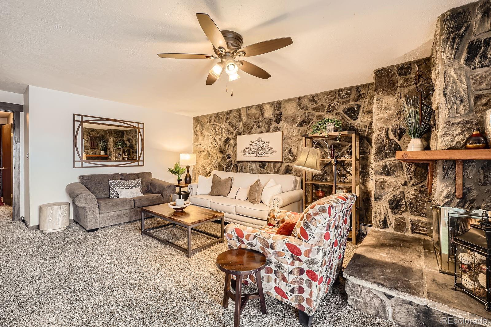 120 E Lane, Unit 109 Dillon, CO 80435 - Photo 10 of 39 a living room with furniture and a chandelier