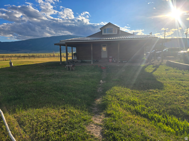 34200 Coulam Road Swan Lake, ID 83281 - Photo 2 of 24 Log-sided residence with a covered porch extending across the front elevation