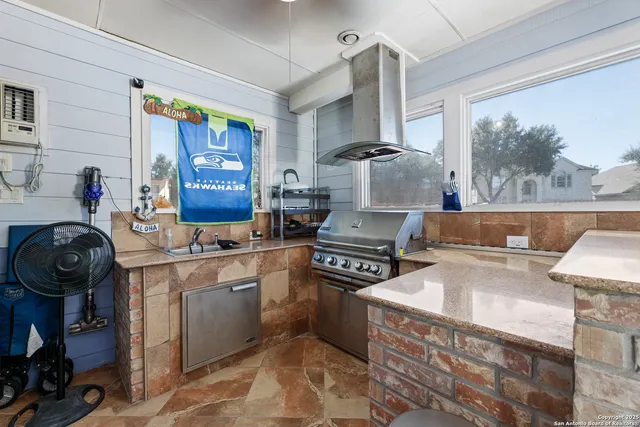 a kitchen with a stove a sink and a refrigerator