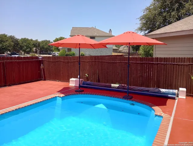 a view of swimming pool with an outdoor seating
