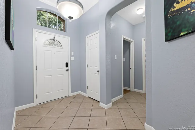 a view of a hallway with wooden floor and windows