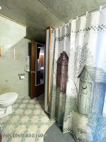 a view of a yard with plants and trees