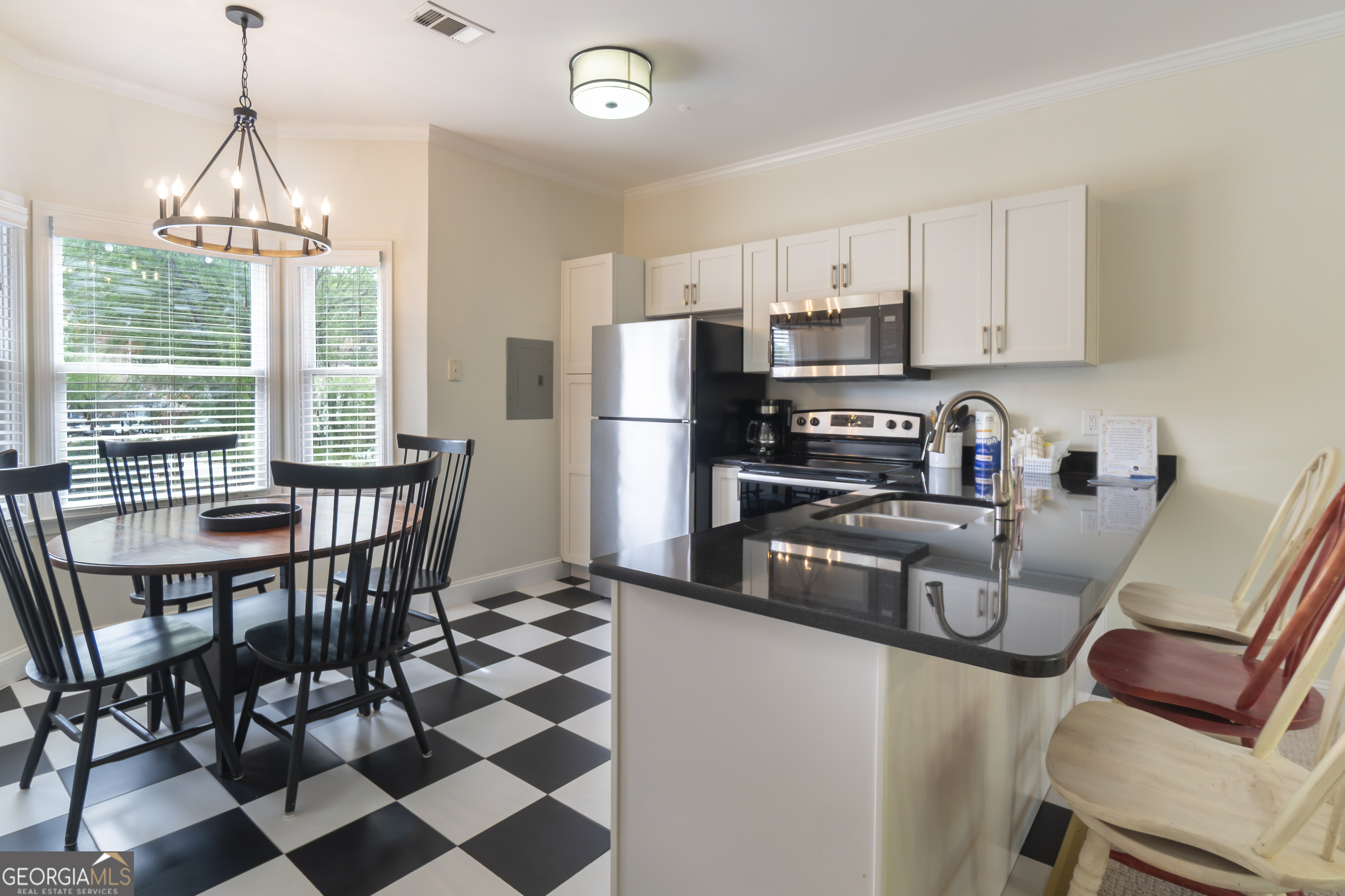 892 Edelweiss Strasse Helen, GA 30545 - Photo 13 of 36 a kitchen with stainless steel appliances granite countertop a stove a refrigerator a sink a stove and white cabinets