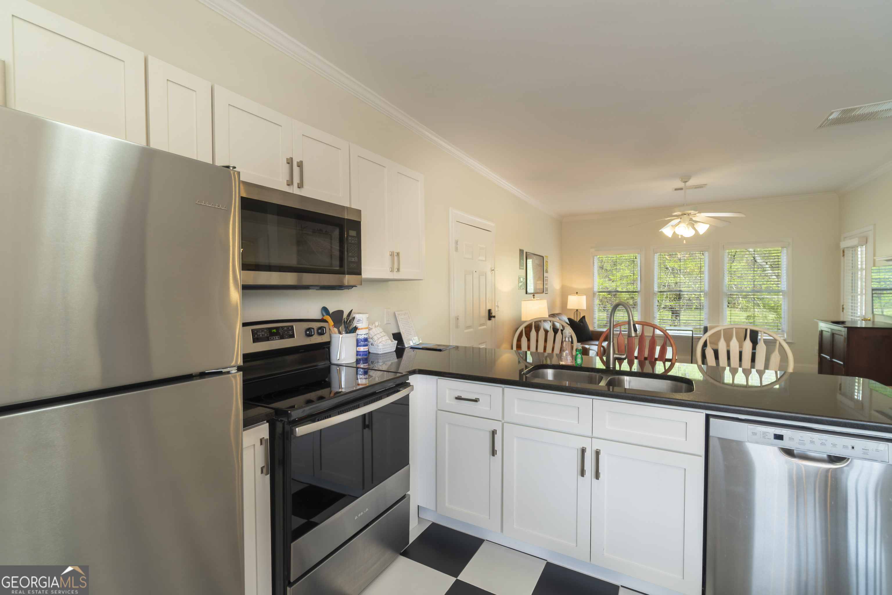 892 Edelweiss Strasse Helen, GA 30545 - Photo 16 of 36 a kitchen with stainless steel appliances a sink stove refrigerator and cabinets