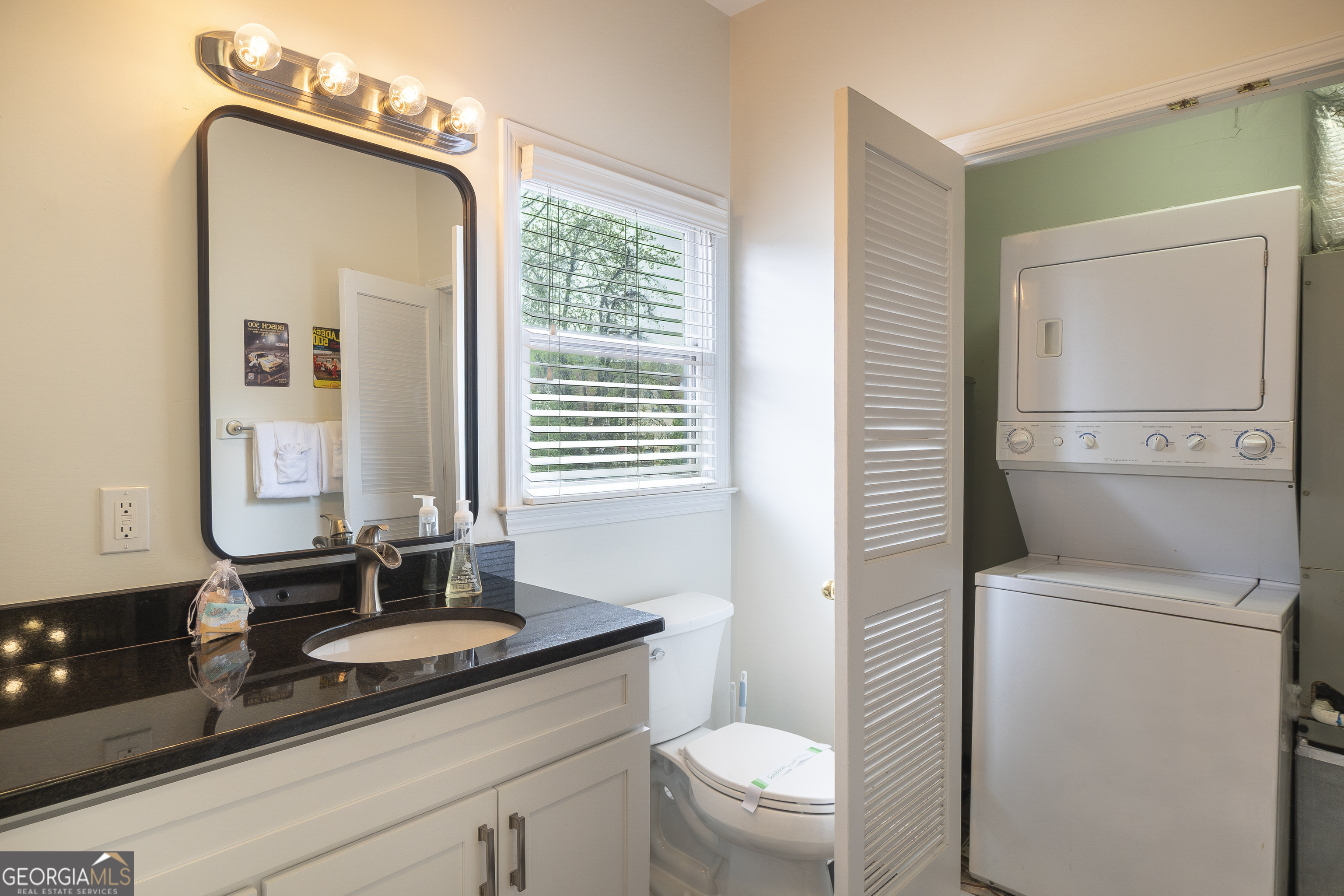 892 Edelweiss Strasse Helen, GA 30545 - Photo 27 of 36 a bathroom with a granite countertop sink toilet and mirror