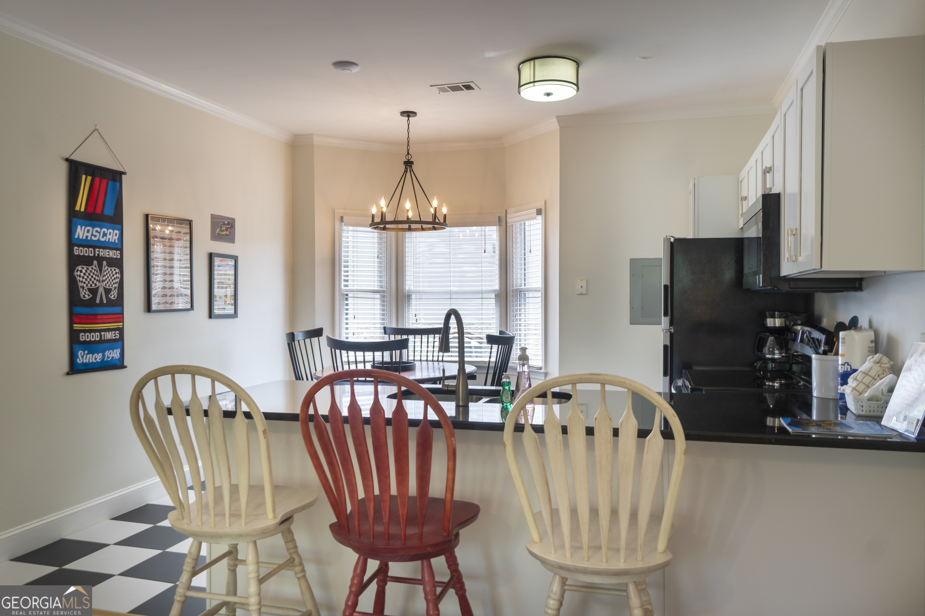 892 Edelweiss Strasse Helen, GA 30545 - Photo 7 of 36 a view of a dining room with furniture a chandelier and wooden floor