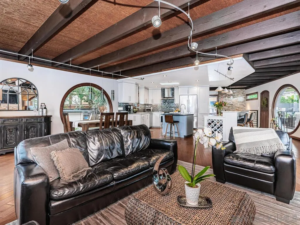 1838 Laurel Road Oceanside, CA 92054 - Photo 15 of 71 a living room with furniture a fireplace wooden floor and a rug