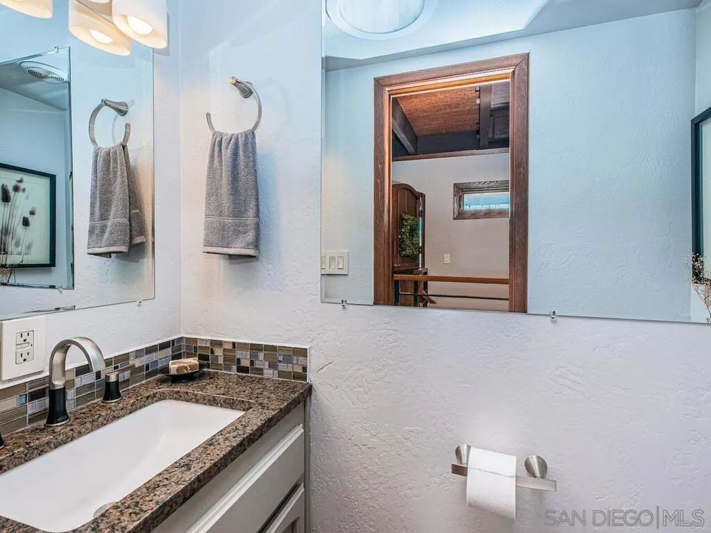1838 Laurel Road Oceanside, CA 92054 - Photo 24 of 71 a bathroom with a granite countertop sink and a mirror
