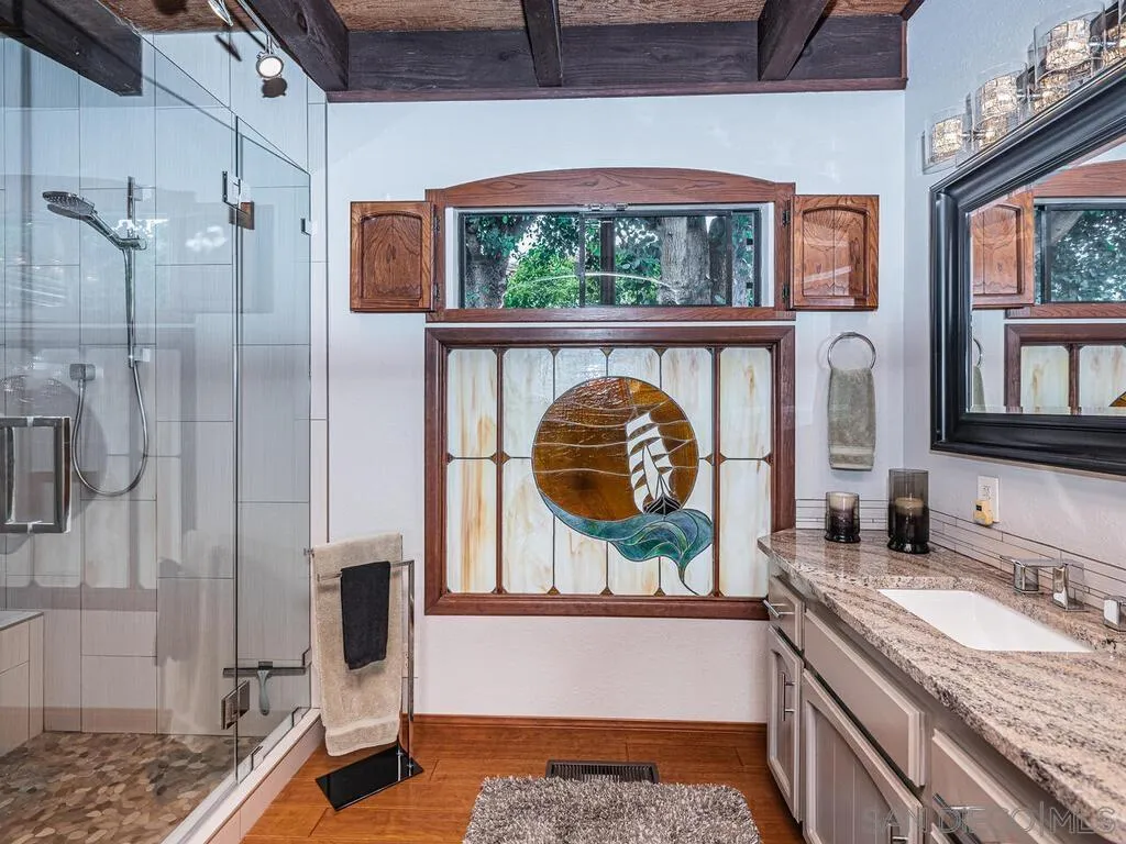 1838 Laurel Road Oceanside, CA 92054 - Photo 26 of 71 a bathroom with a granite countertop sink and a mirror
