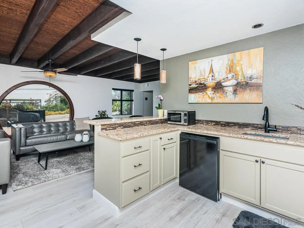 1838 Laurel Road Oceanside, CA 92054 - Photo 38 of 71 a spacious bathroom with a granite countertop sink mirror and a bathtub