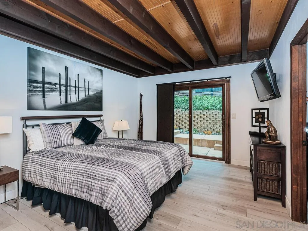 1838 Laurel Road Oceanside, CA 92054 - Photo 39 of 71 a bedroom with a large bed a flat tv screen and dresser