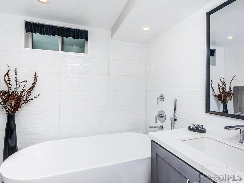 1838 Laurel Road Oceanside, CA 92054 - Photo 44 of 71 a bathroom with a tub sink and mirror