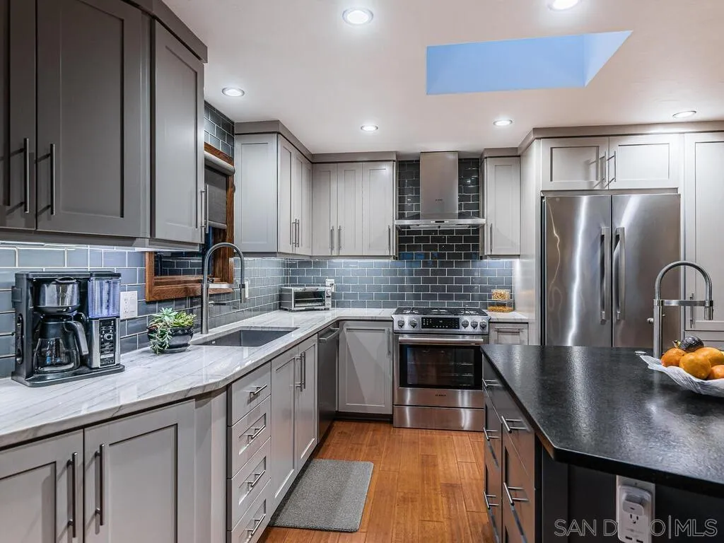 1838 Laurel Road Oceanside, CA 92054 - Photo 5 of 71 a kitchen with stainless steel appliances granite countertop a sink refrigerator and cabinets