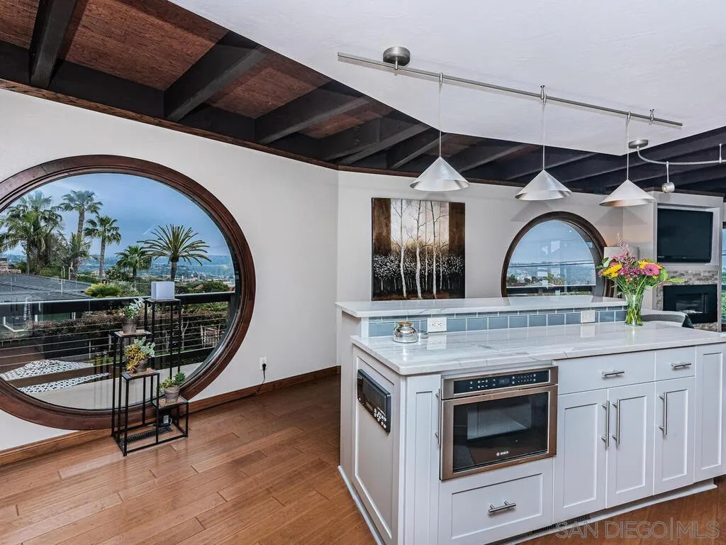 1838 Laurel Road Oceanside, CA 92054 - Photo 10 of 71 a kitchen with a stove a flat screen tv and a fireplace