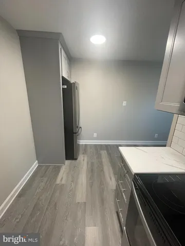 a view of an empty room and wooden floor