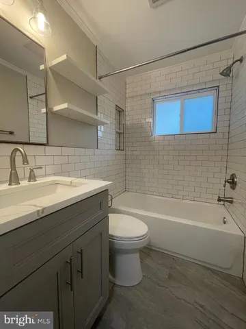 a bathroom with a sink a toilet and bathtub