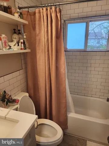 a bathroom with a sink toilet and tub