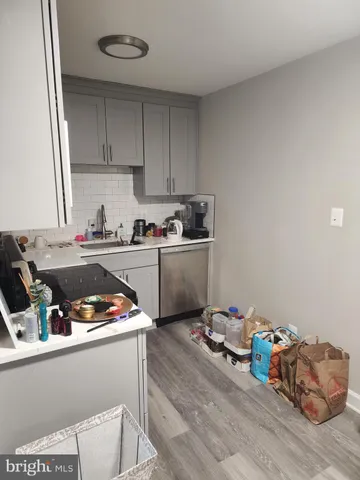 a kitchen with a small stove and white cabinets