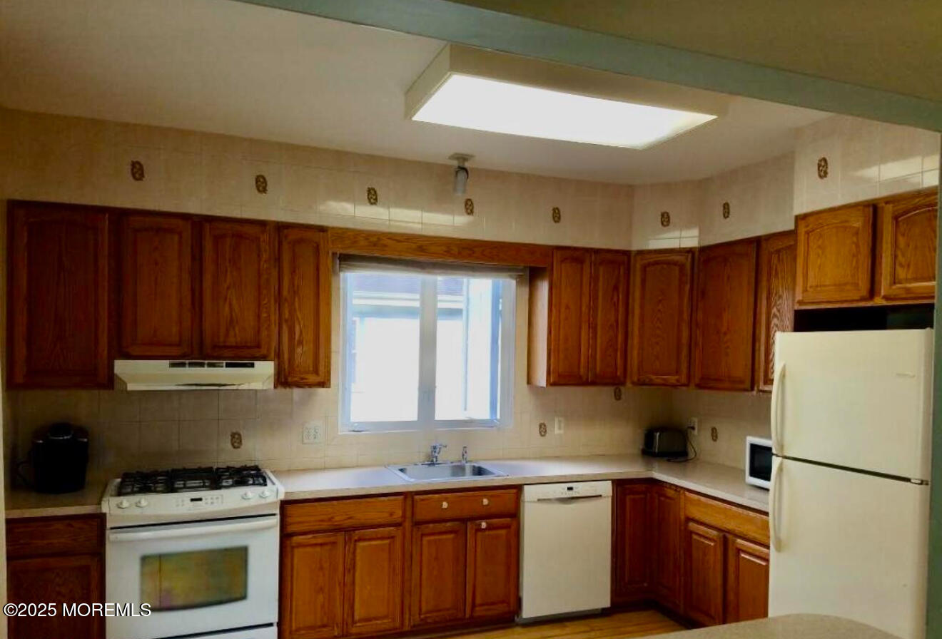 95 Poplar Avenue Deal, NJ 07723 - Photo 5 of 9 a kitchen with a sink a stove a refrigerator and cabinets