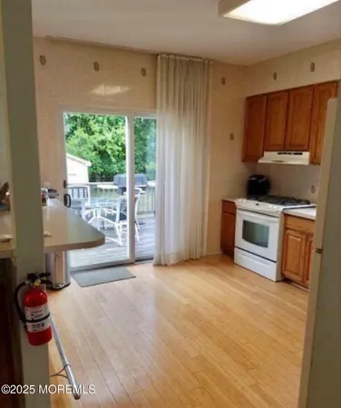 a kitchen with a stove a sink and a refrigerator
