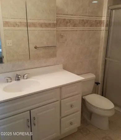 a bathroom with a sink a toilet and a shower