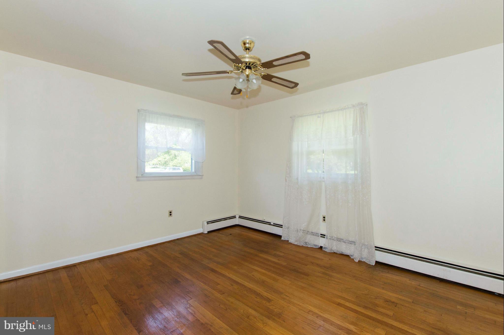 2903 Ashwood Road Fallston, MD 21047 - Photo 21 of 30 an empty room with wooden floor fan and windows