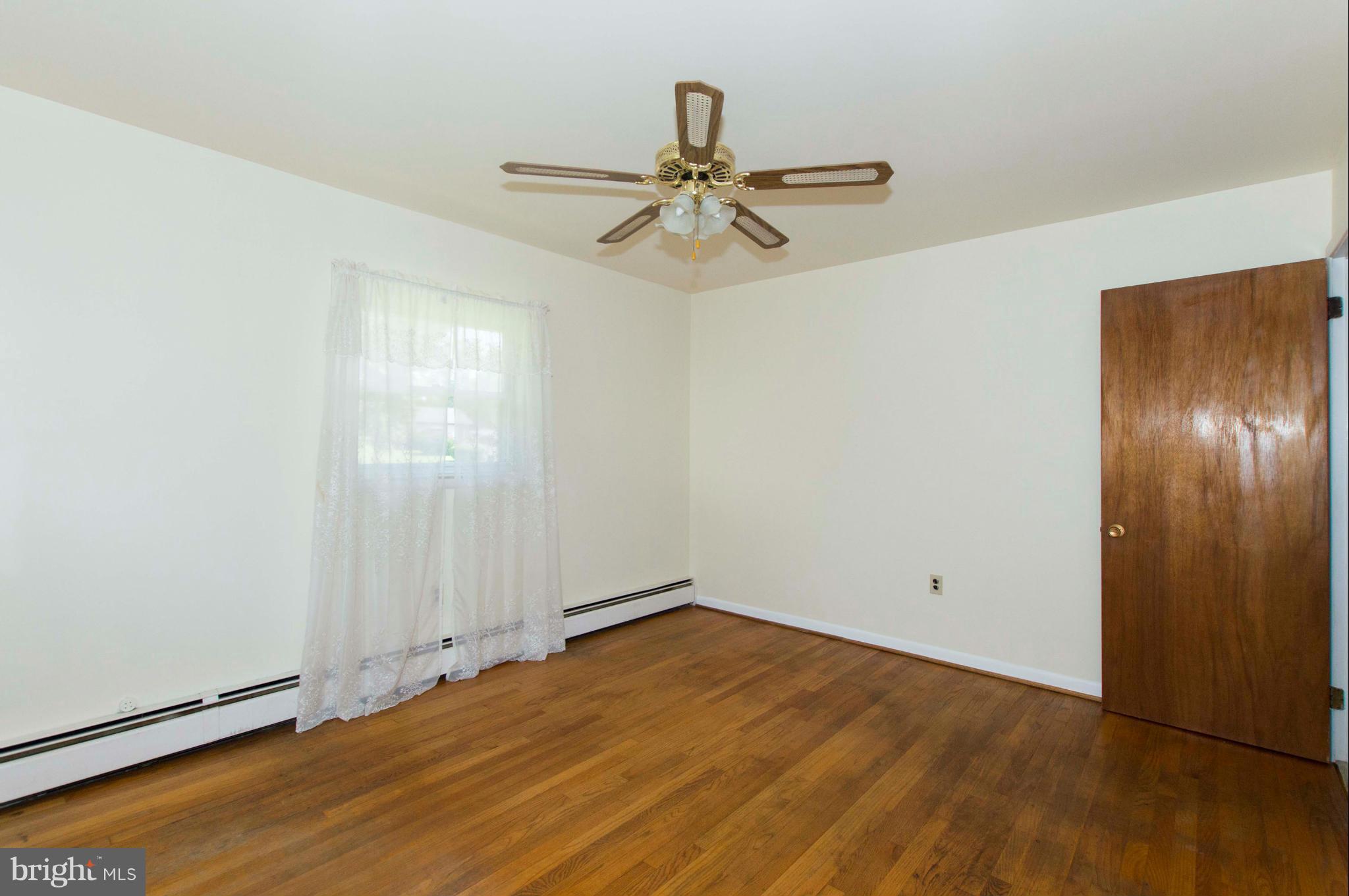 2903 Ashwood Road Fallston, MD 21047 - Photo 23 of 30 an empty room with wooden floor closet and windows