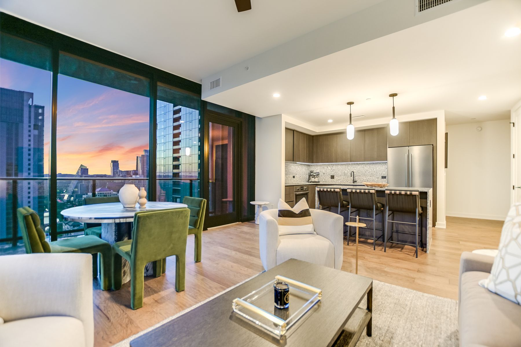 84 East Avenue, Unit 3909 Austin, TX 78701 - Photo 2 of 26 Living area with light wood finished floors, a city view, a ceiling fan, and expansive windows