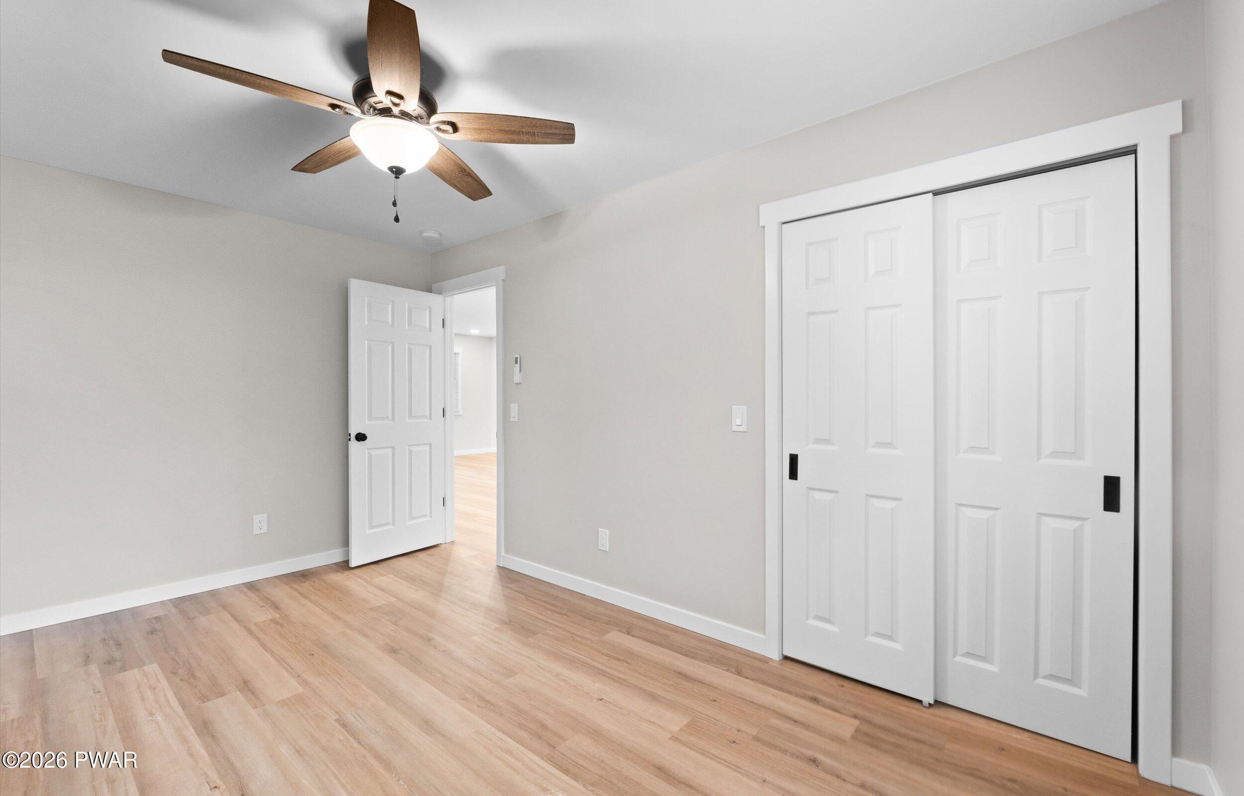9 High Point Court Lake Ariel, PA 18436 - Photo 16 of 40 an empty room with wooden floor fan and windows