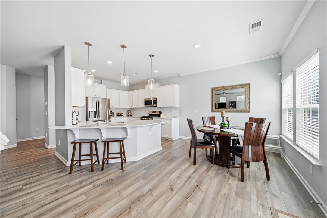 208 Grassy Creek Way Pendleton, SC 29670 - Photo 8 of 43 A streamlined kitchen layout offers an inviting breakfast bar and a dining area, perfect for daily meals.
