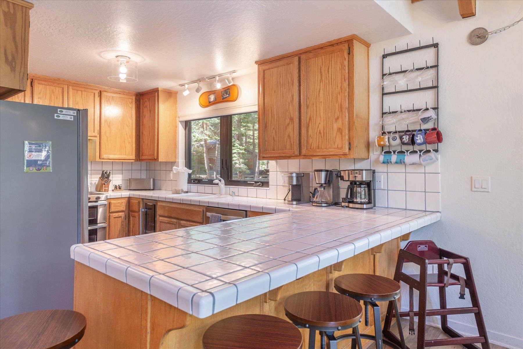 6255 Flicker Avenue Homewood, CA 96141 - Photo 7 of 22 a kitchen with a table chairs and a refrigerator