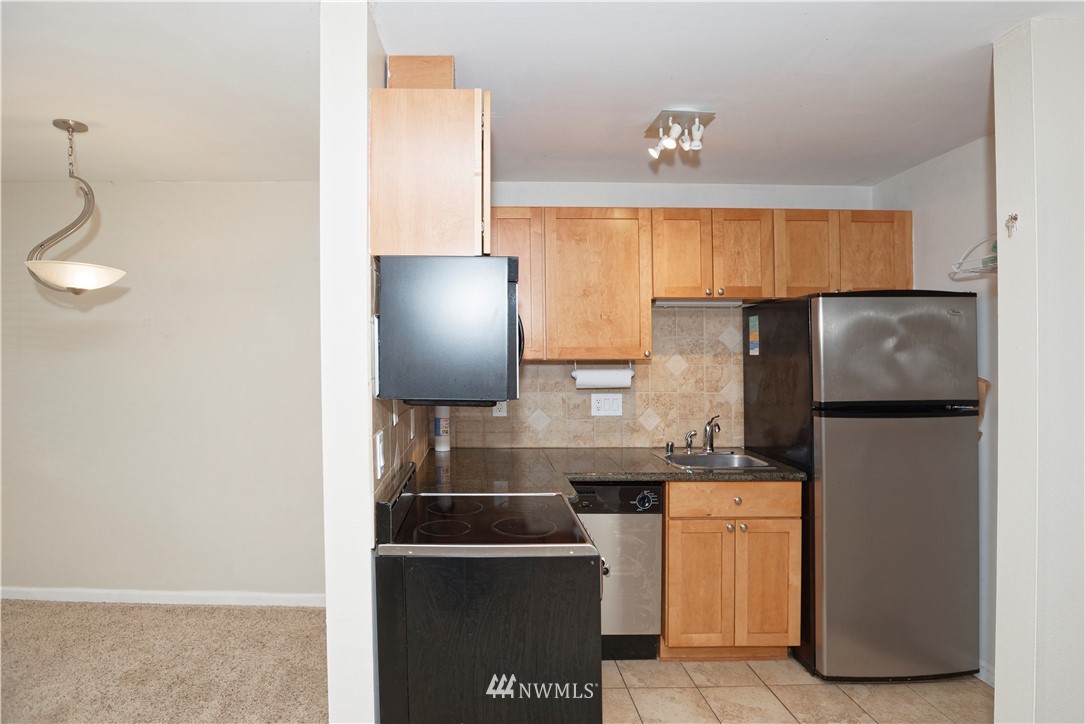 604 North 3rd Street, Unit 7 Tacoma, WA 98403 - Photo 2 of 11 a kitchen with a refrigerator and a sink