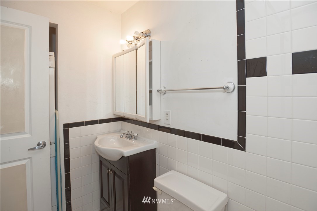 604 North 3rd Street, Unit 7 Tacoma, WA 98403 - Photo 11 of 11 a bathroom with a sink and a mirror