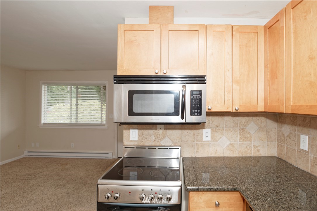 604 North 3rd Street, Unit 7 Tacoma, WA 98403 - Photo 4 of 11 a stove top oven sitting inside of a kitchen