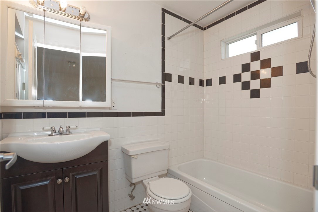 604 North 3rd Street, Unit 7 Tacoma, WA 98403 - Photo 10 of 11 a bathroom with a sink toilet and shower
