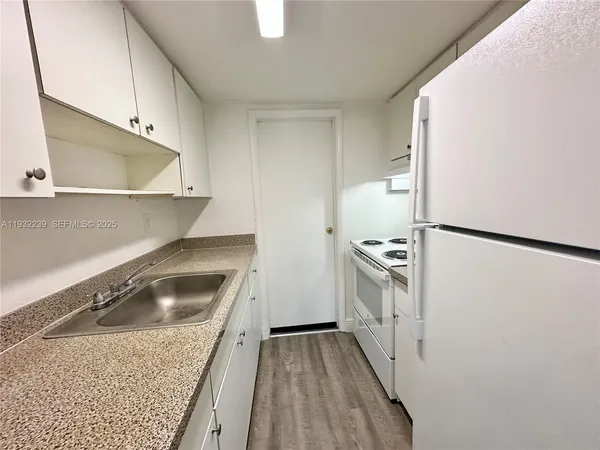 a kitchen with a sink a stove and refrigerator