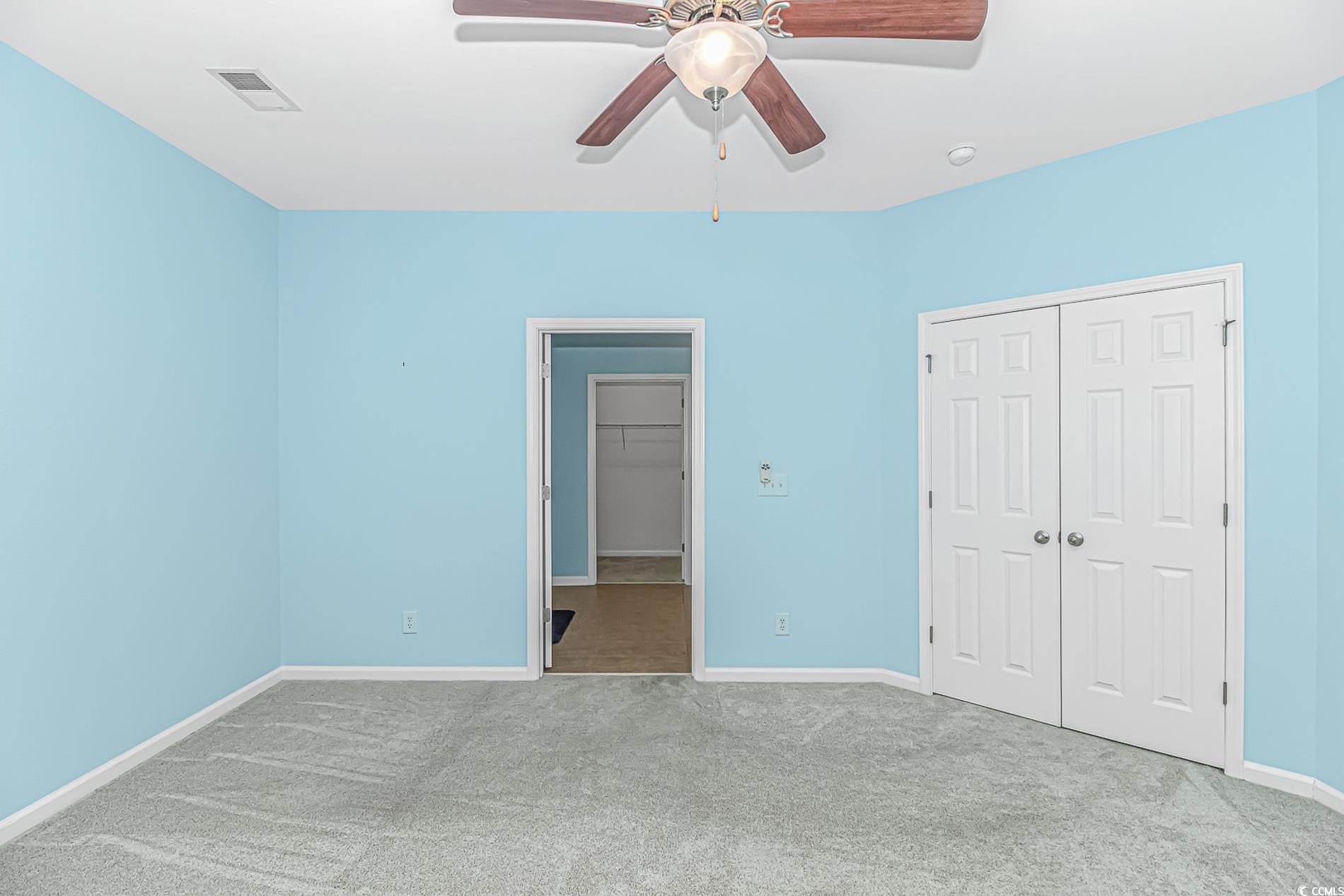 139 Chenoa Drive, Unit D Murrells Inlet, SC 29576 - Photo 12 of 34 Unfurnished bedroom with carpet flooring, ceiling fan, and a spacious closet