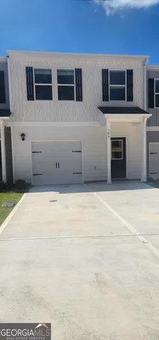 a living room with stainless steel appliances kitchen island a stove and a microwave