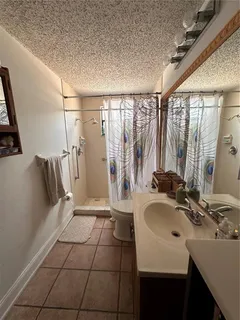 a bathroom with a sink a mirror and a bathtub