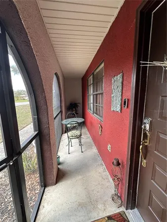 a view of front door with furniture and a window