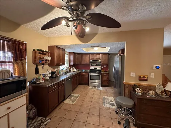a kitchen with granite countertop lots of counter top space appliances and furniture