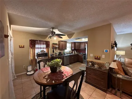 a living room with furniture kitchen view and a dining table