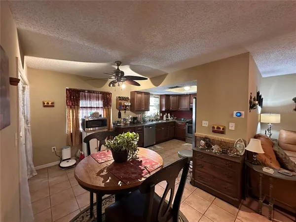 a living room with furniture kitchen view and a dining table