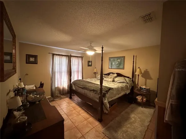 a bed room with a bed window and a chair