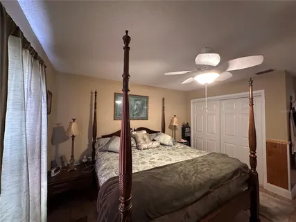a bedroom with a bed and a chandelier