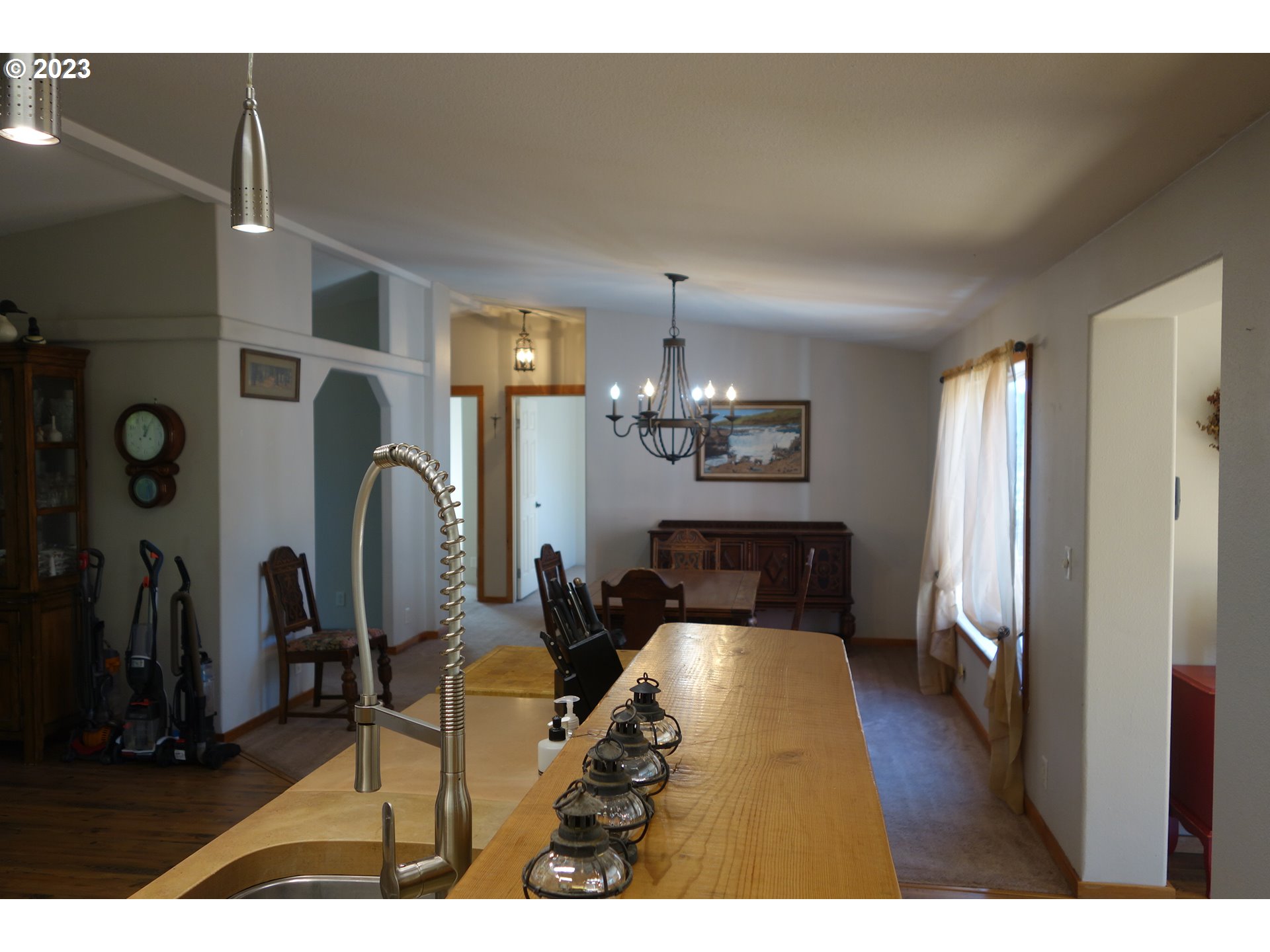 182 Bates Road White Salmon, WA 98672 - Photo 11 of 38 a living room with furniture and a chandelier