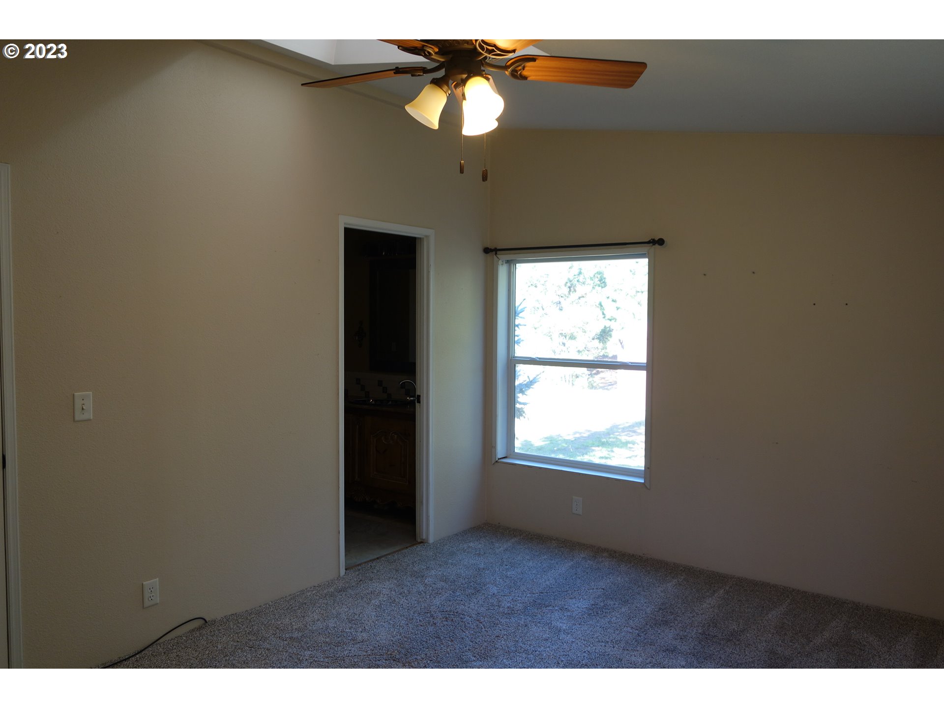 182 Bates Road White Salmon, WA 98672 - Photo 16 of 38 a view of an empty room with window and chandelier fan