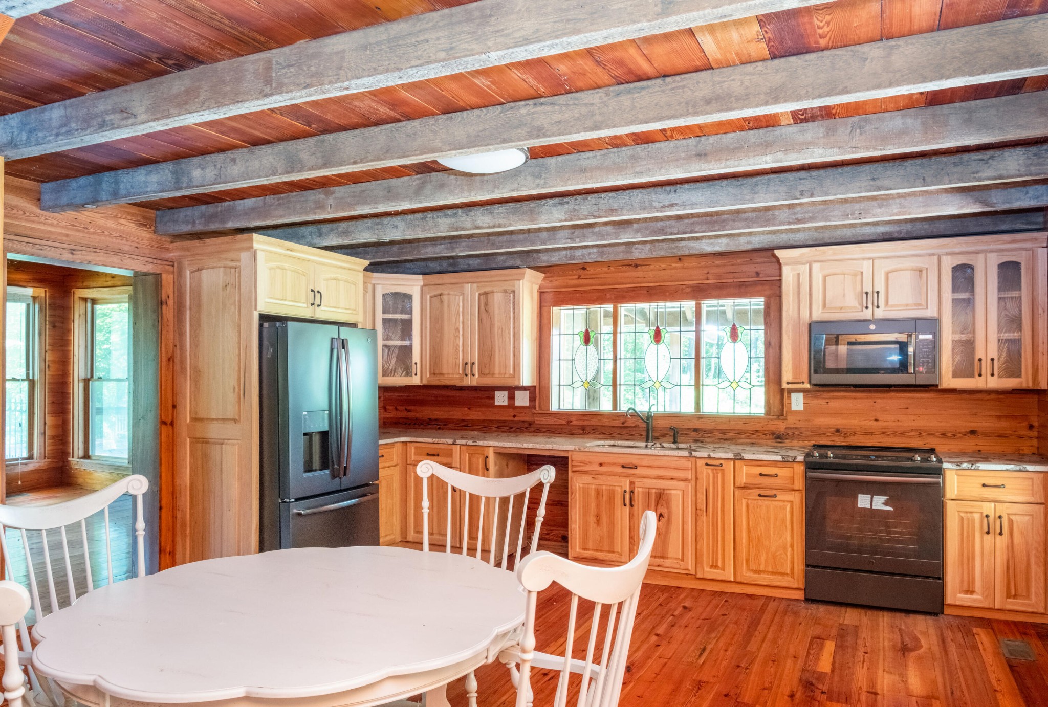 4340 Holland Chattoogaville Road Lyerly, GA 30730 - Photo 22 of 47 a kitchen with stainless steel appliances granite countertop a kitchen island a stove a table and chairs