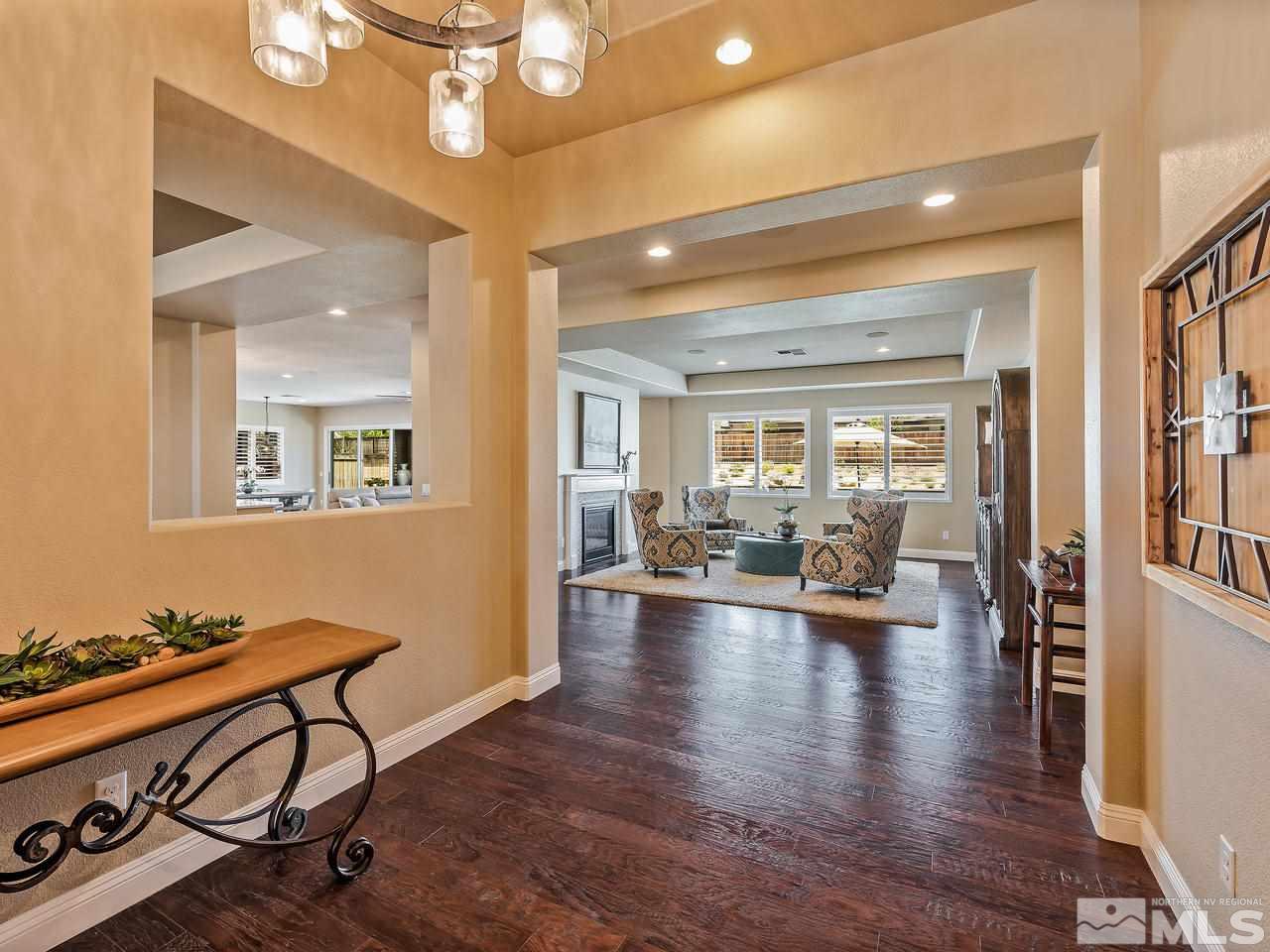 9790 Cardigan Bay Lane Reno, NV 89521 - Photo 3 of 40 a view of a livingroom with dining room and wooden floor