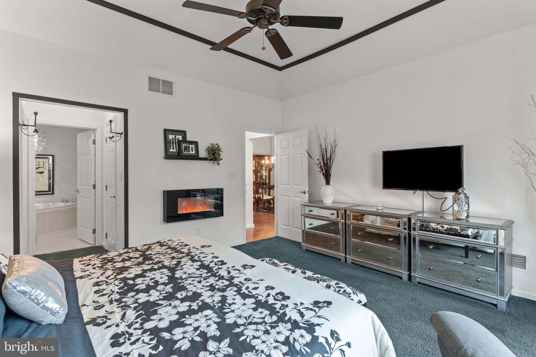 613 Bellflower Road Langhorne, PA 19047 - Photo 18 of 28 a bedroom with a bed and a flat screen tv